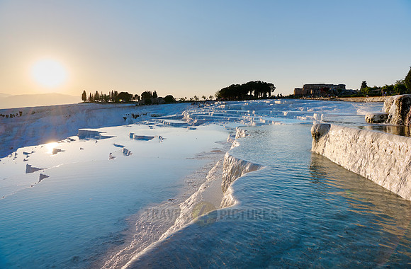 sunset behind Pamukkale travertine terraces