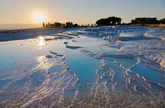 sunset behind Pamukkale travertine terraces
