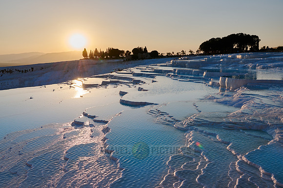 sunset behind Pamukkale travertine terraces