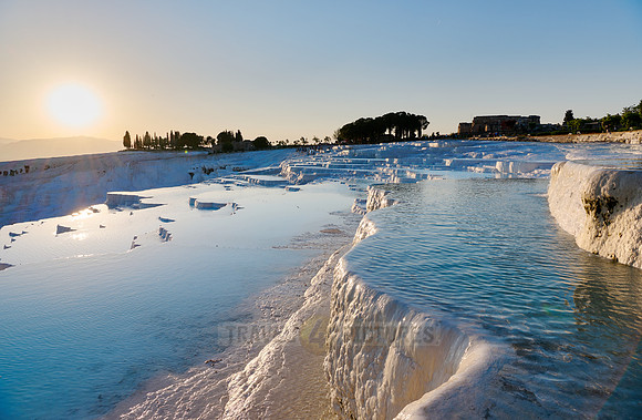 sunset behind Pamukkale travertine terraces