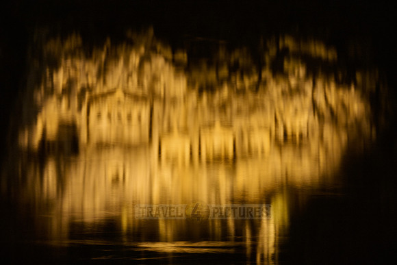 water reflection of illuminated Lycian rock tombs in a rock face of Dalyan