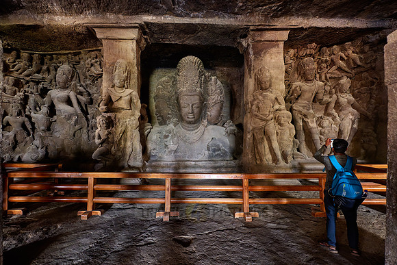 tourist in front of the Eternal Shiva, the Sadashiva, Elephanta caves