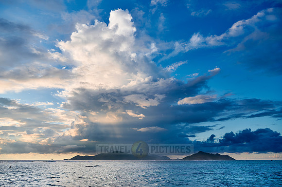 Cloud towers over Praslin in the evening seen from Anse Source D'Argent