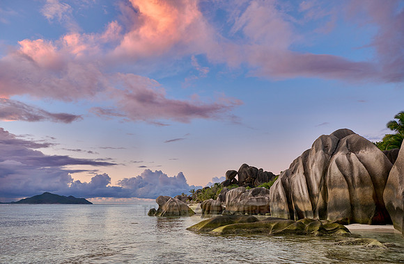 Cloud towers over Praslin in the evening seen from Anse Source D'Argent