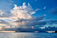 Cloud towers over Praslin in the evening seen from Anse Source D'Argent