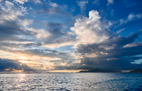 Cloud towers over Praslin in the evening seen from Anse Source D'Argent