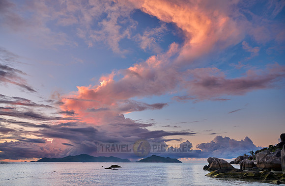 Cloud towers over Praslin in the evening seen from Anse Source D'Argent