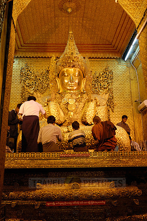 uddha with thick layer of golden leaves in Mahamuni Pagoda