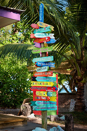 colorful information signs with distances to places around the world on La Digue