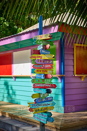 colorful information signs with distances to places around the world on La Digue