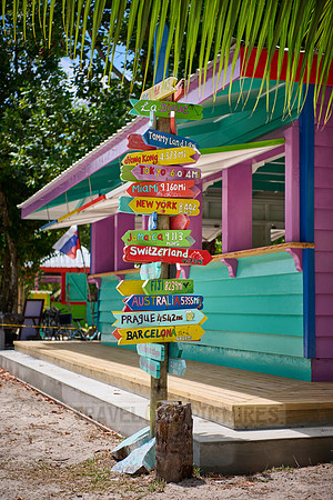 colorful information signs with distances to places around the world on La Digue