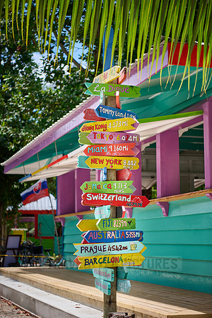 colorful information signs with distances to places around the world on La Digue