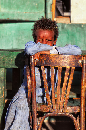 Local Egyptian child with typical clothes on chair