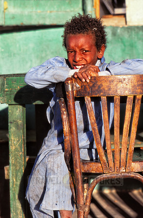 Local Egyptian child with typical clothes on chair
