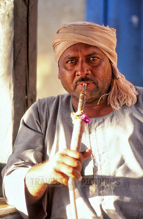 Egyptian man with typical clothes smoking shisha