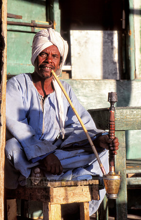 Egyptian man with typical clothes smoking shisha