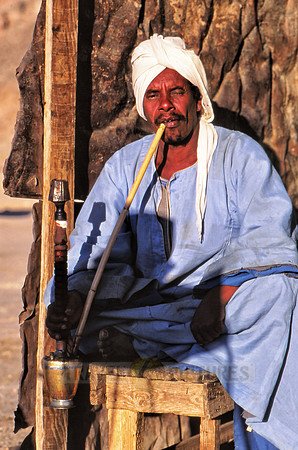 Egyptian man with typical clothes smoking shisha