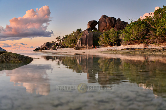 characteristic rock formation with colorful clouds on the beach of Anse Source D'Argent