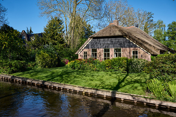 canal and traditional house in dutch Giethoorn village