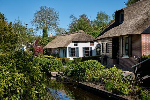 canal and traditional house in dutch Giethoorn village