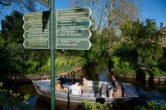 sign, canal and traditional house in dutch Giethoorn village