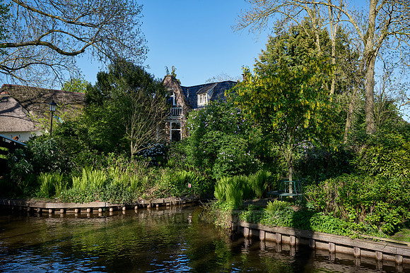 canal and traditional house in dutch Giethoorn village