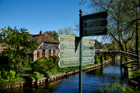 sign, canal and traditional house in dutch Giethoorn village