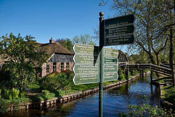 sign, canal and traditional house in dutch Giethoorn village