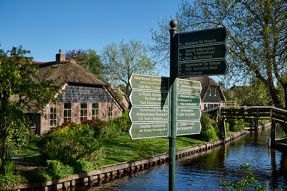 sign, canal and traditional house in dutch Giethoorn village