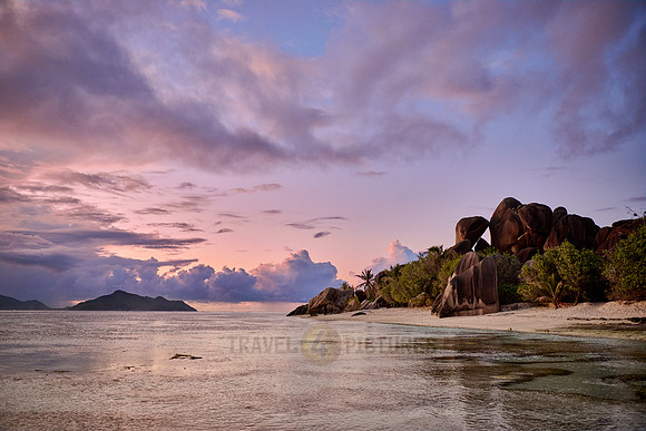 characteristic rock formation with colorful clouds on the beach of Anse Source D'Argent