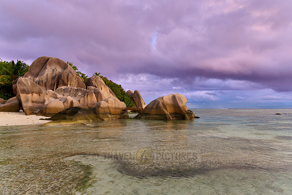 characteristic rock formation with colorful clouds on the beach of Anse Source D'Argent
