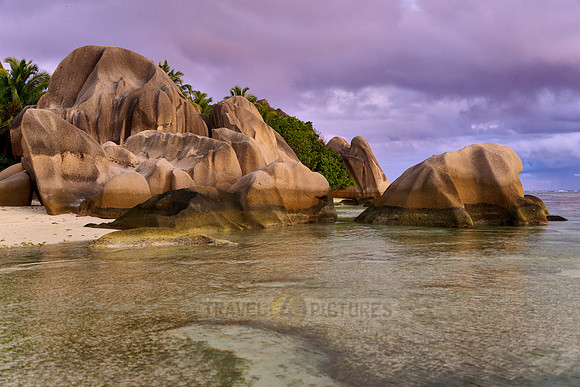 characteristic rock formation with colorful clouds on the beach of Anse Source D'Argent