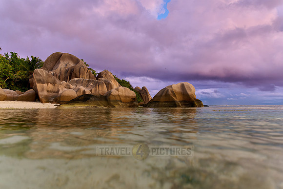 characteristic rock formation with colorful clouds on the beach of Anse Source D'Argent
