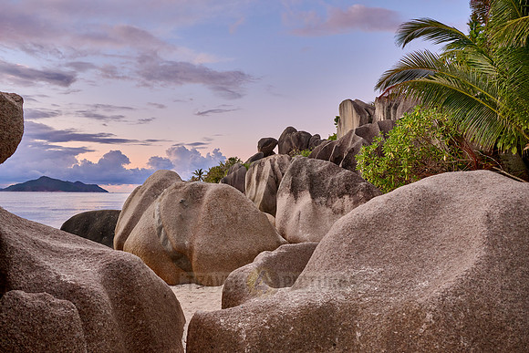 characteristic rock formation with colorful clouds on the beach of Anse Source D'Argent