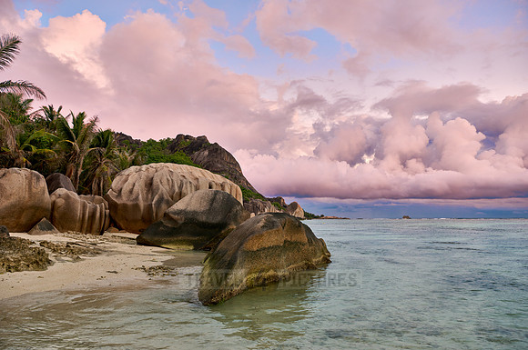characteristic rock formation with colorful clouds on the beach of Anse Source D'Argent