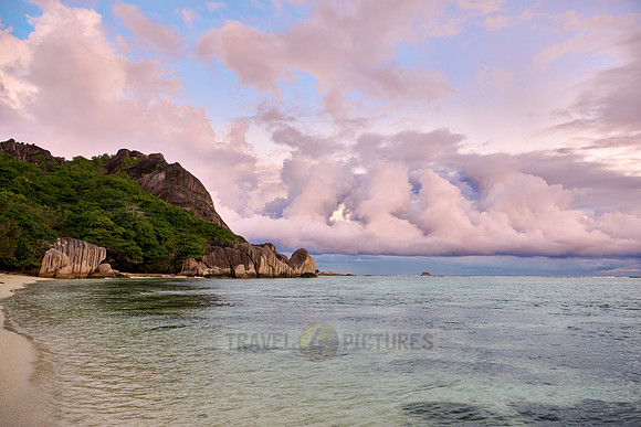 characteristic rock formation with colorful clouds on the beach of Anse Source D'Argent