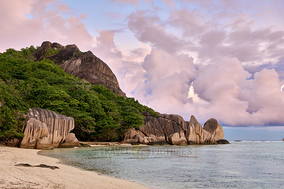 characteristic rock formation with colorful clouds on the beach of Anse Source D'Argent
