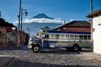 traditional colorful local bus in Antigua in front of volcano