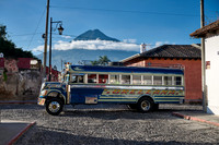 traditional colorful local bus in Antigua in front of volcano
