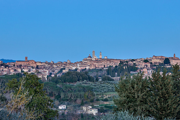 view on illuminated Siena from a distance