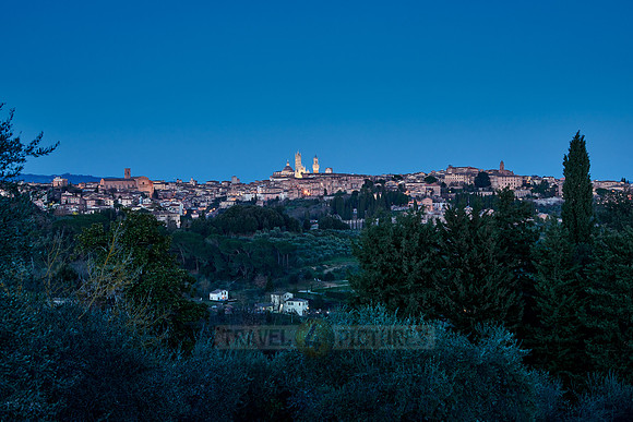 view on illuminated Siena from a distance