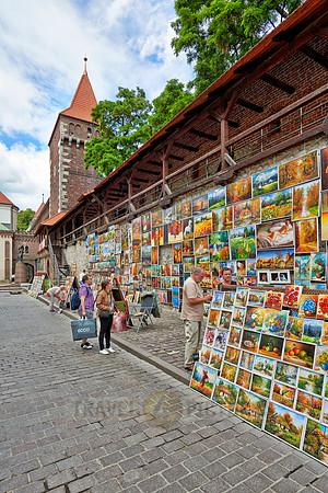 stalls with paintings at city wall