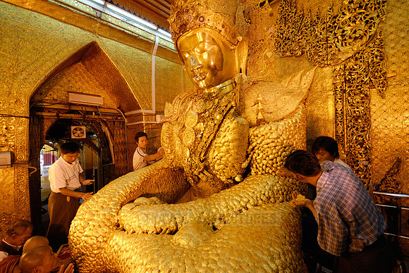 uddha with thick layer of golden leaves in Mahamuni Pagoda