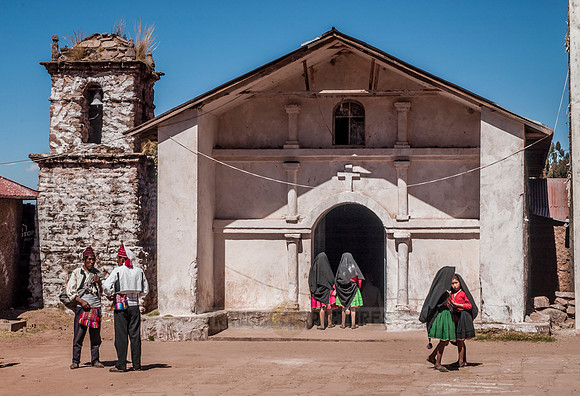 locals in front of church on Isla Taquile on Lake Titicaca