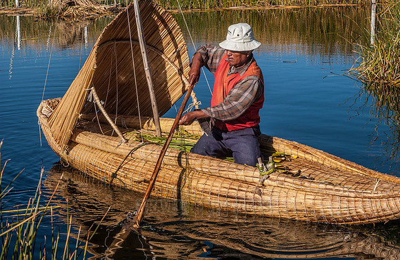 fisherman of local Uros tribe on reed boat