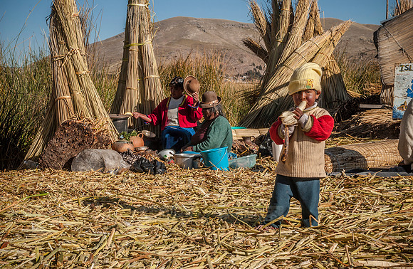 Indigenas and child of local Uros on Lake Titicaca