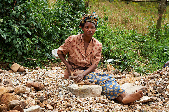 local woman prepars stones for road building
