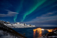 Aurora Borealis over winter landscape in fjord of Husøy
