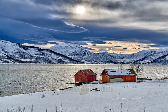 winter landscape with typical red house in Senja