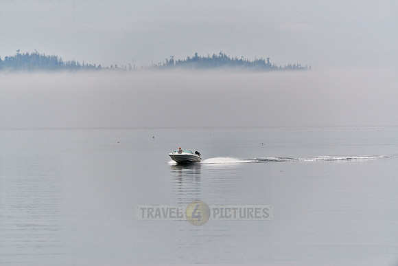 motorboat driving through the fog of Johnstone Strait|